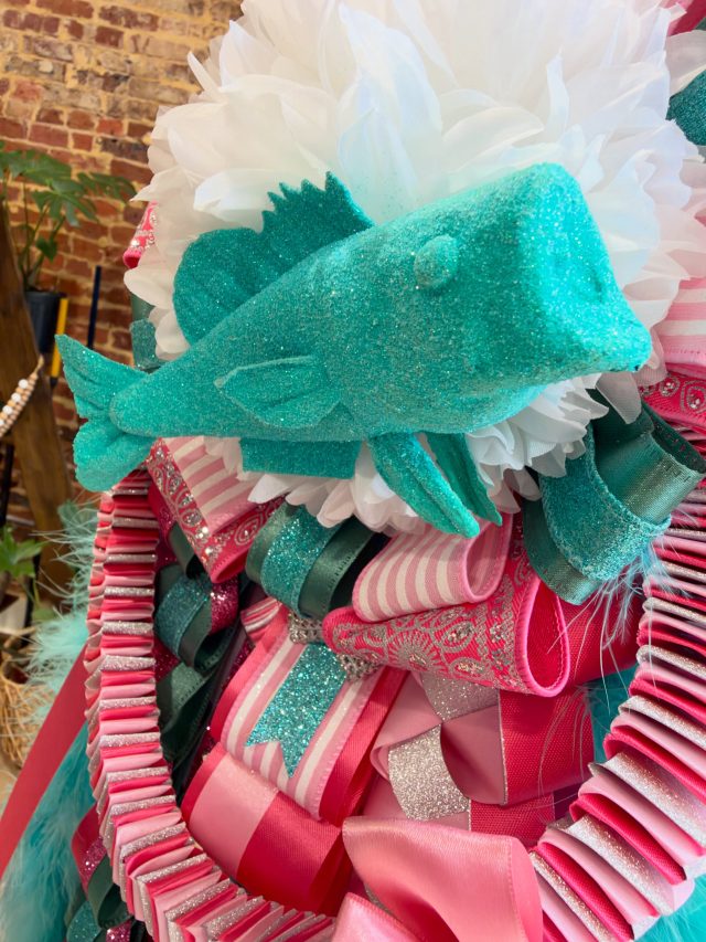 What’s not to love about an all teal glitzed-out big-mouth bass for HoCo26!?!? 💕 #doyouboo #homecoming 

✨ We are over our capacity on homecoming mums for 2026! We cannot THANK YOU enough for getting on our list asap and we will post these beauties as they come out!!! 😍 #weloveyou #welovelove